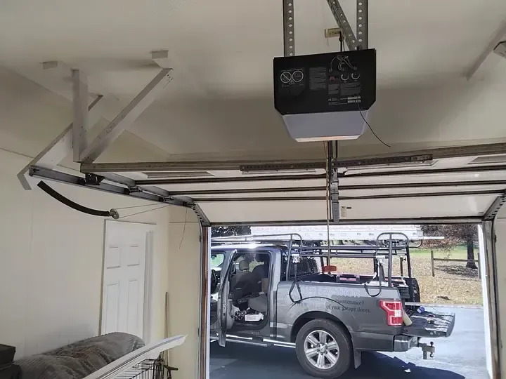 Garage interior with a truck inside and an automatic opener.