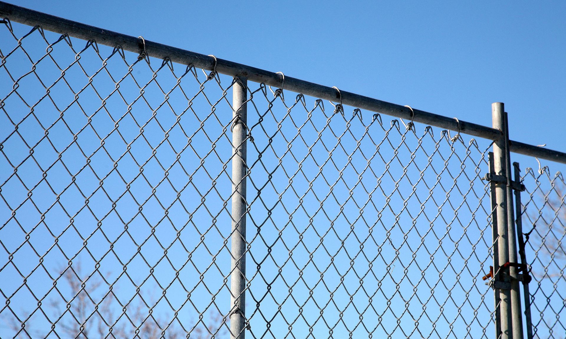 a chain link fence with a blue sky in the background .