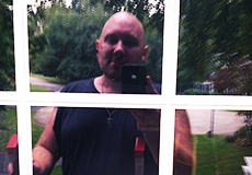 Man taking selfie in cleaned window