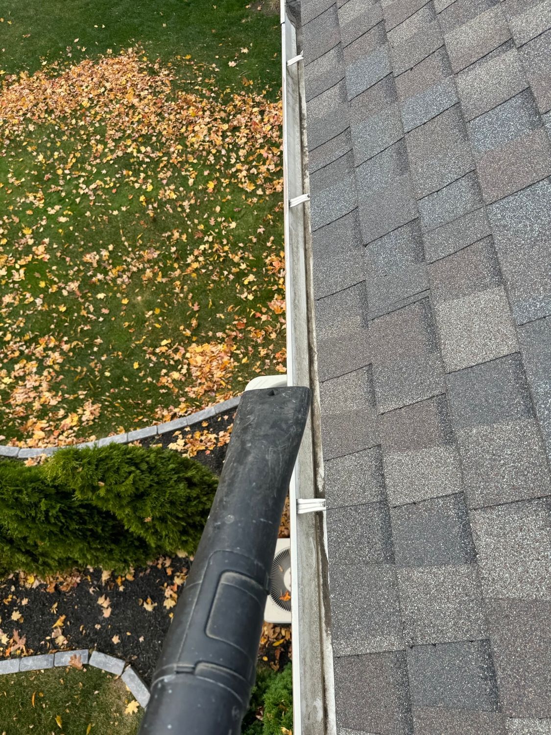 Gutter with leaves getting blown out.