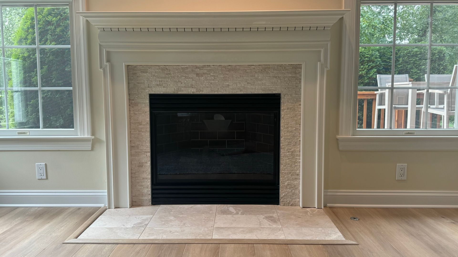 There is a fireplace in the middle of the living room.