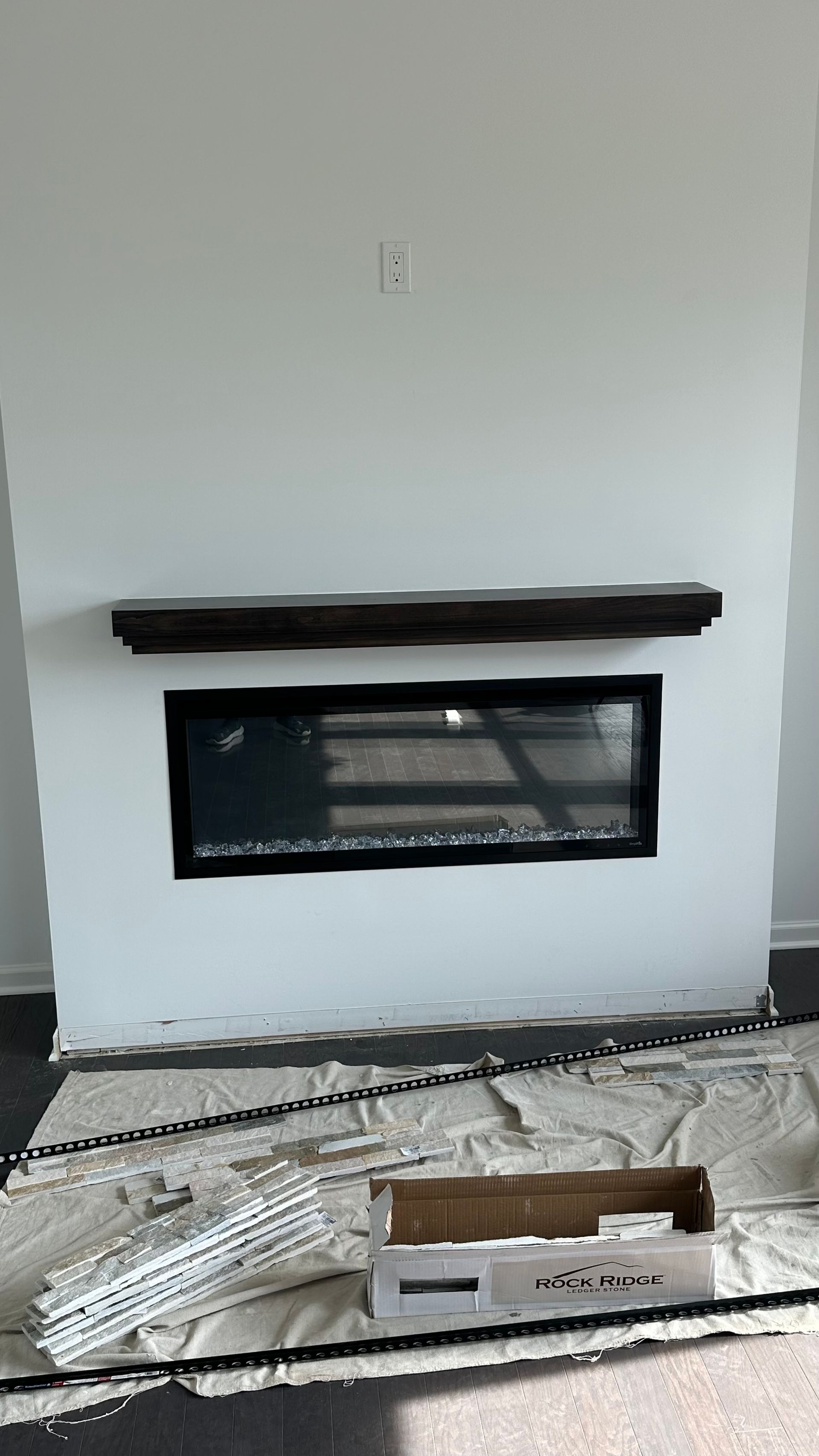 A fireplace is being built in a living room.