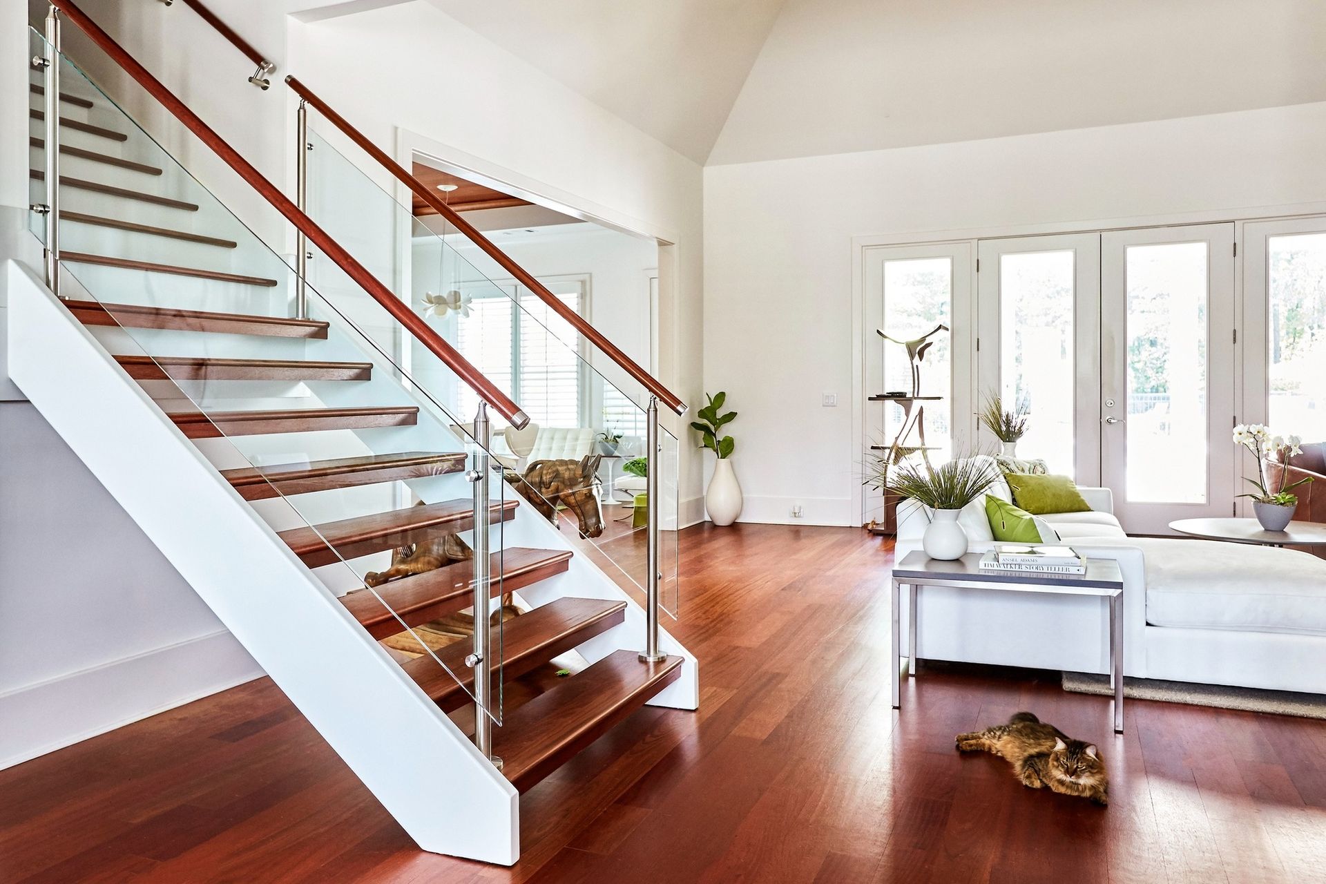 A living room with a staircase leading up to the second floor