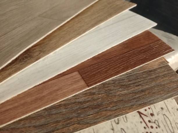A close up of a stack of wooden boards on top of a ruler.
