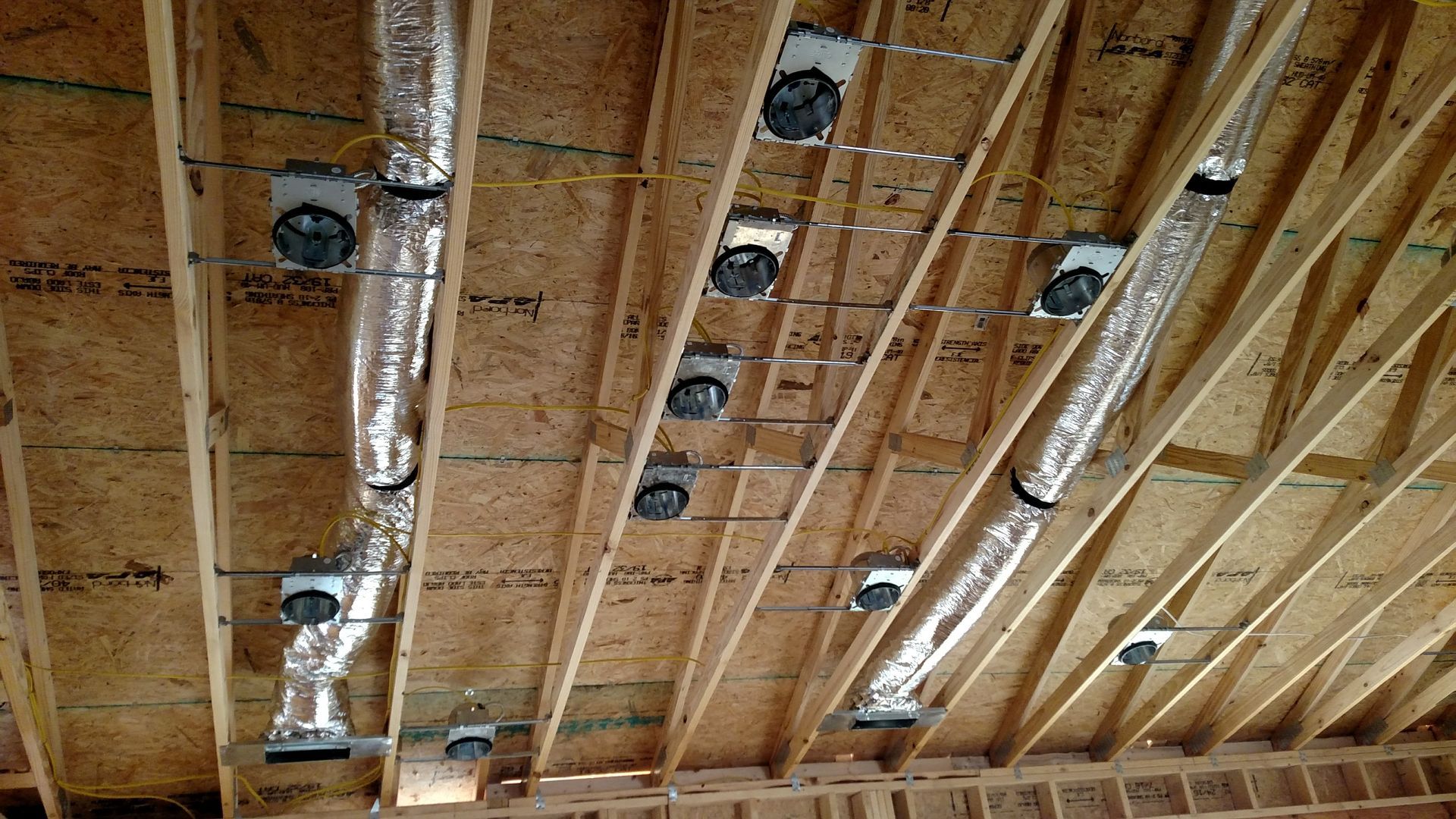 Wooden ceiling frame with air vents and silver ductwork.