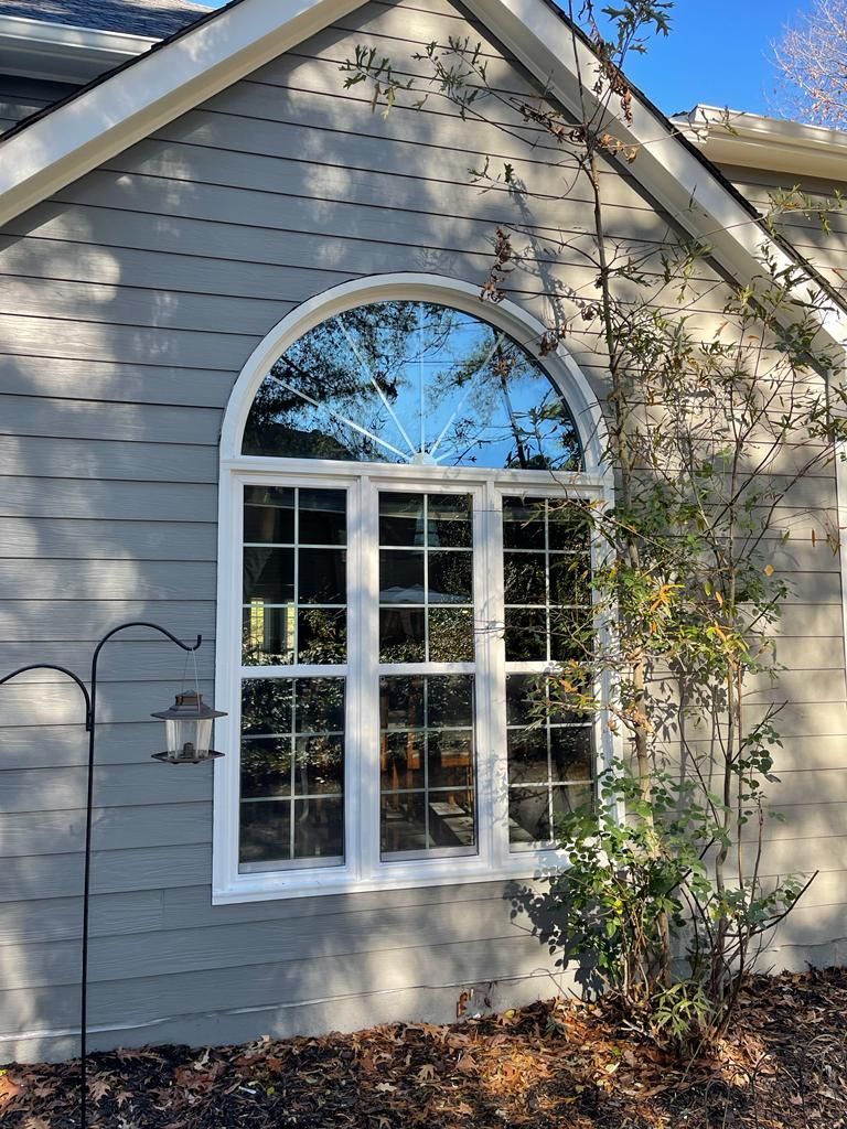 A house with a large window on the side of it.