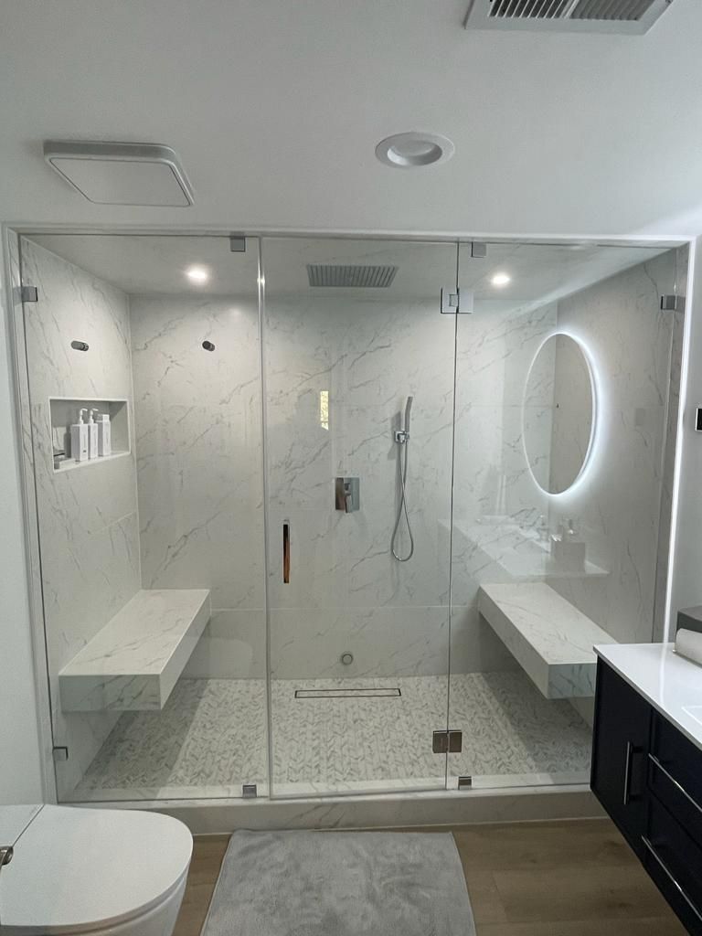 A bathroom with a walk in shower and a toilet.