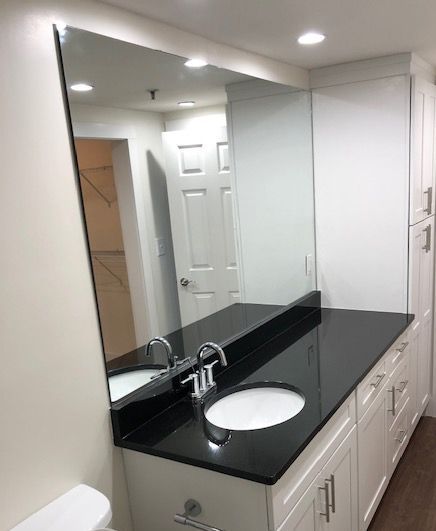 A bathroom with two sinks and a large mirror
