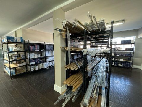 A warehouse filled with shelves filled with lots of supplies.