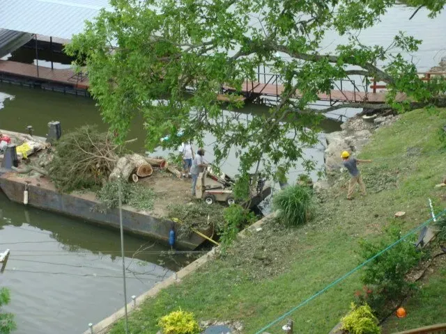 A group of people are working on a boat in the water.