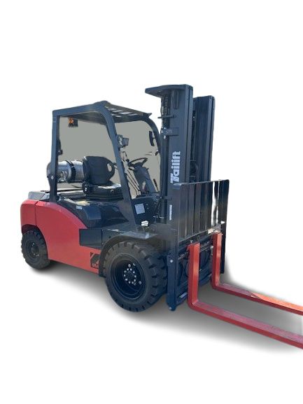 A red forklift is sitting on a white surface.