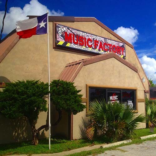 The Music Factory store with Texas flag, plants, and blue sky.