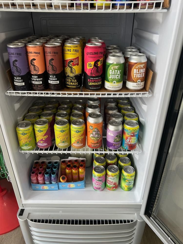 A refrigerator filled with lots of cans of soda.