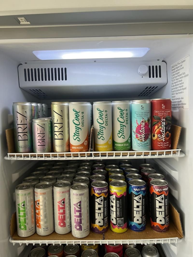 A refrigerator filled with lots of cans of soda.