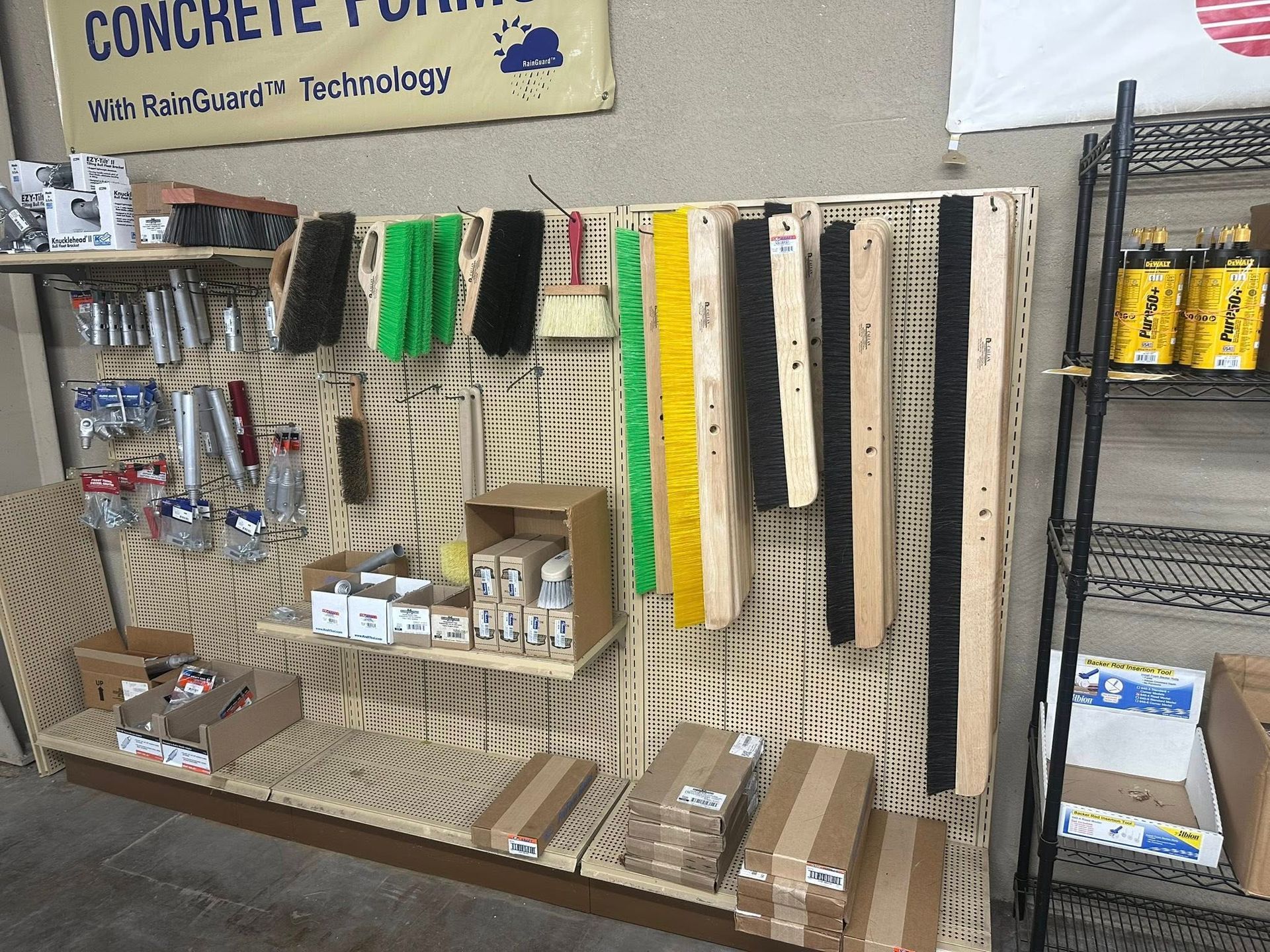 Hardware store display with tools and brushes.
