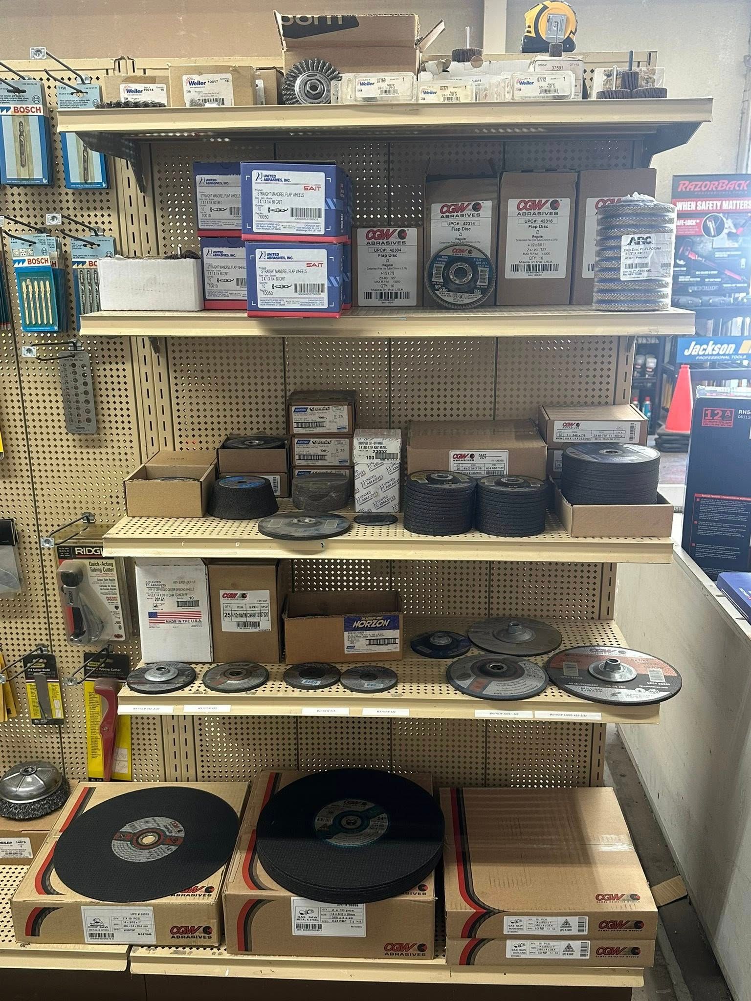 Shelves stocked with automotive parts and cutting discs in a store.