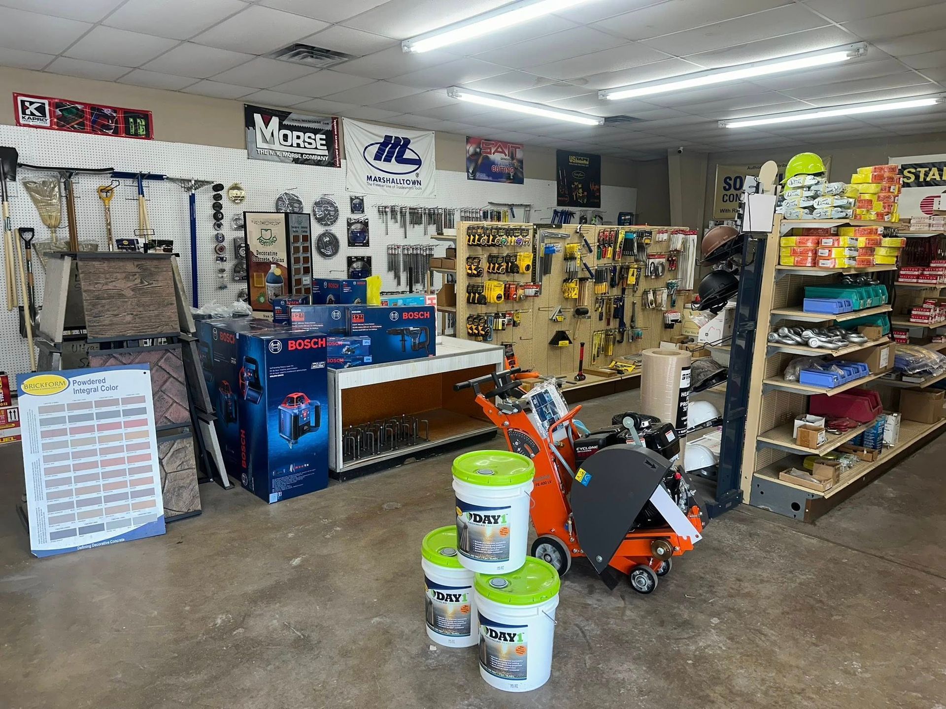 Interior of a hardware store with tools, equipment, and shelves stocked with various items.