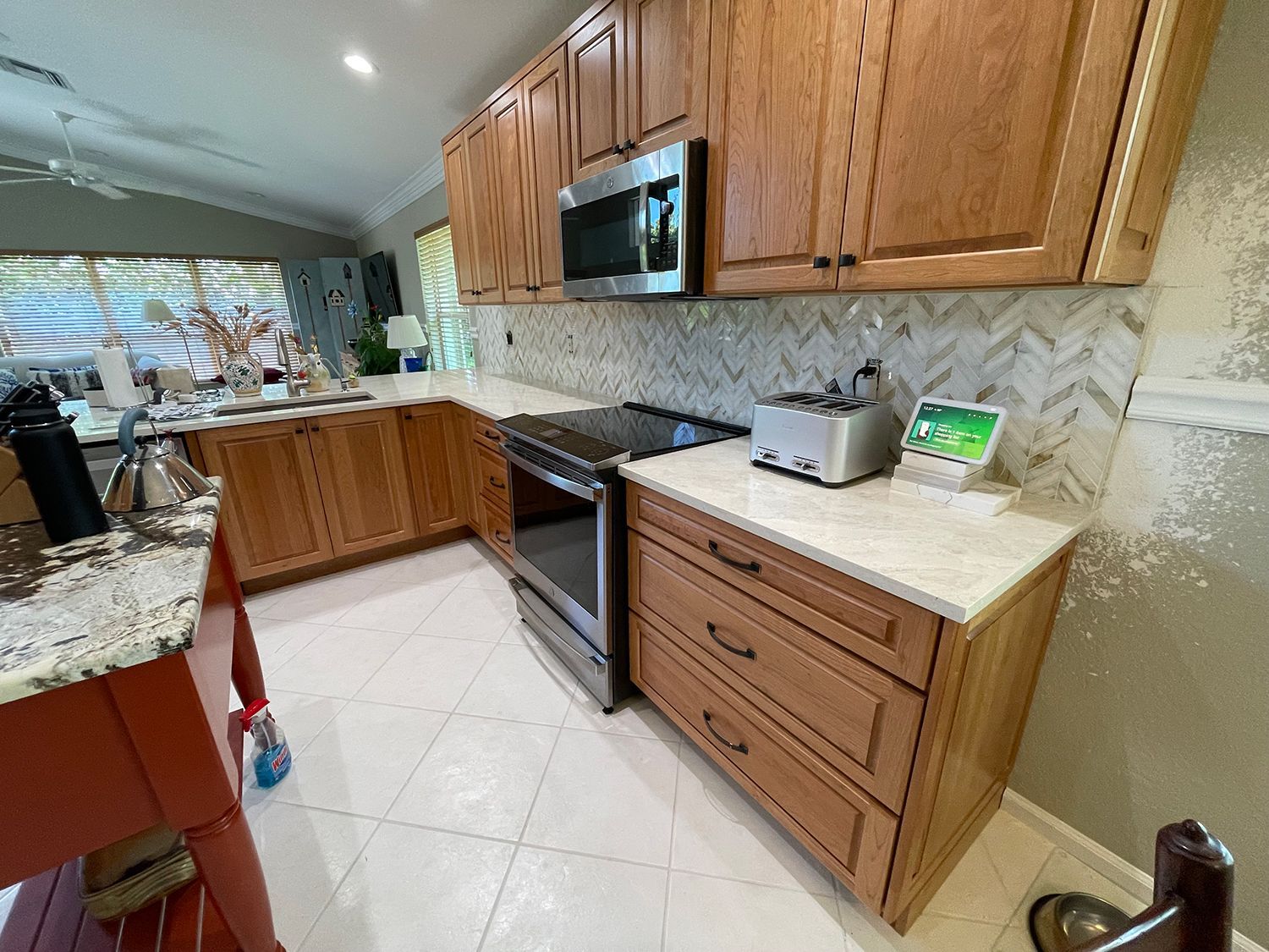 Kitchen with wood cabinets, white countertops, and a stainless steel range and microwave.