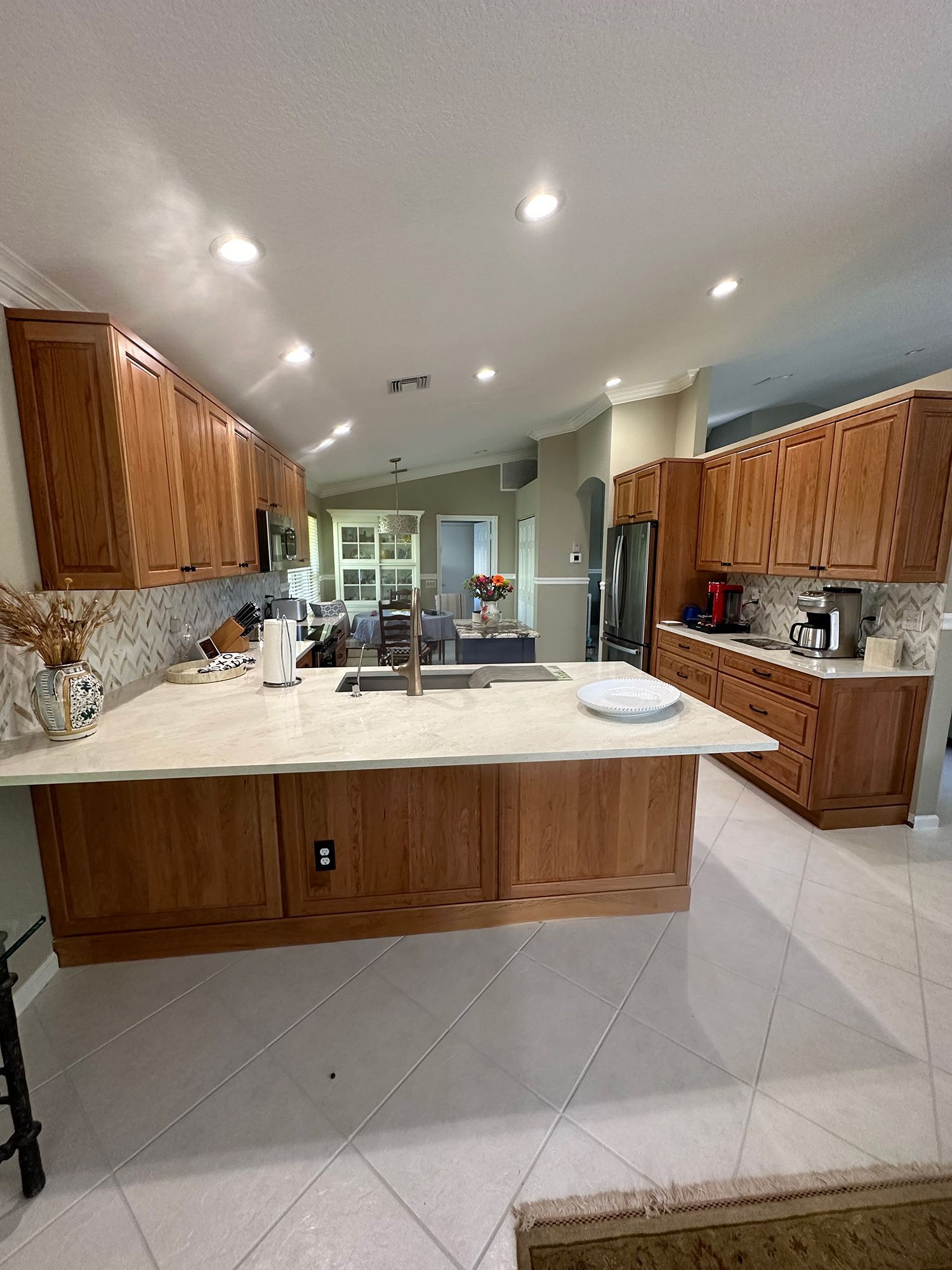 Kitchen with wood cabinets, light countertops, and tile floor.