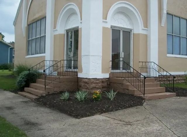 A church with stairs leading up to the front door