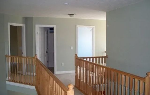 A staircase with a wooden railing in a house