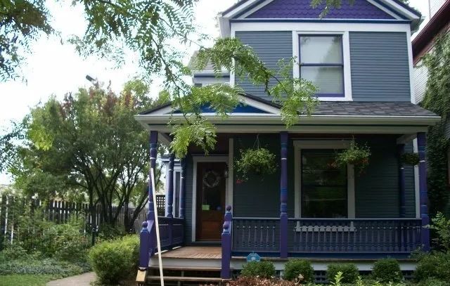 A purple and white house with a porch