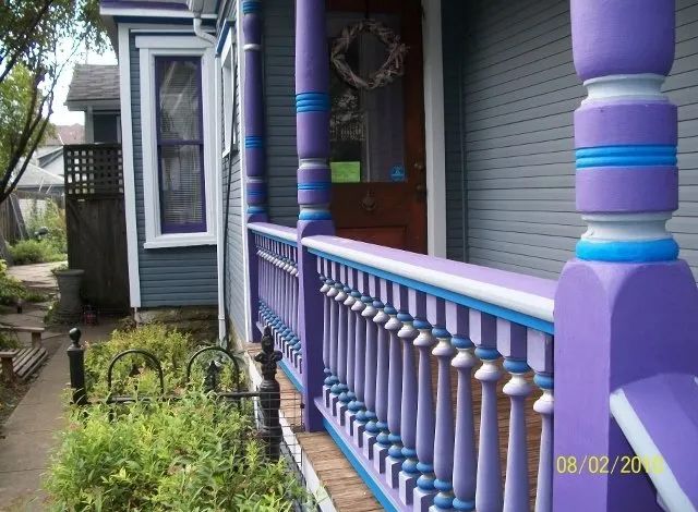 A purple and blue porch railing on a house