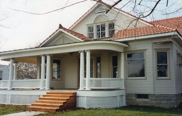 A white house with a porch and stairs