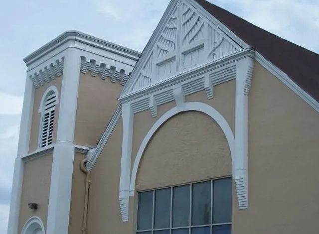 A church with a very tall tower and arched window