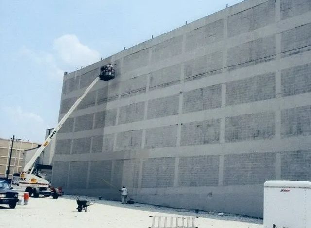 A large building with a crane on the side of it