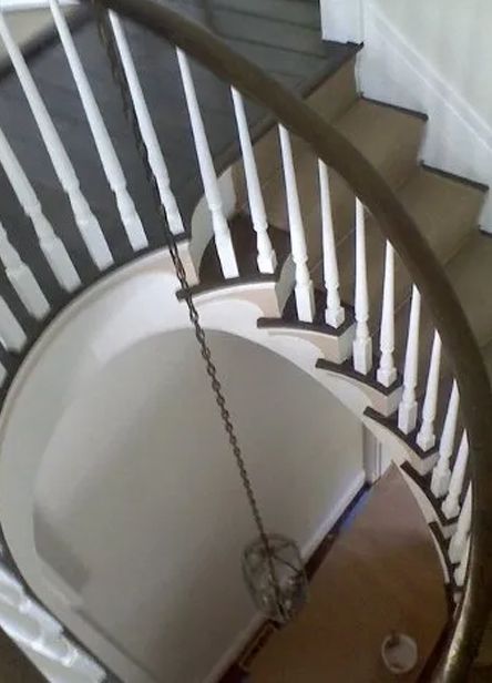 An aerial view of a spiral staircase with white railings