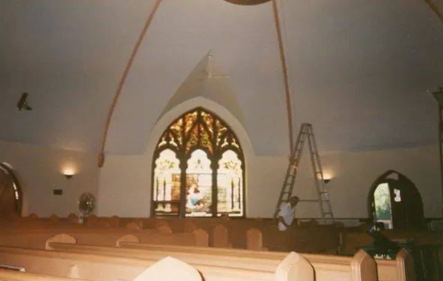 The inside of a church with a stained glass window