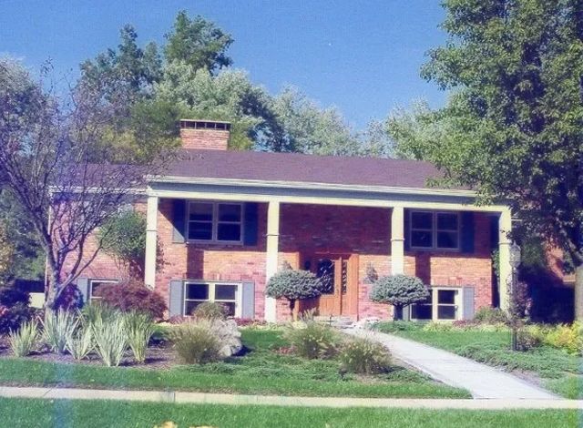 A large brick house with a large porch