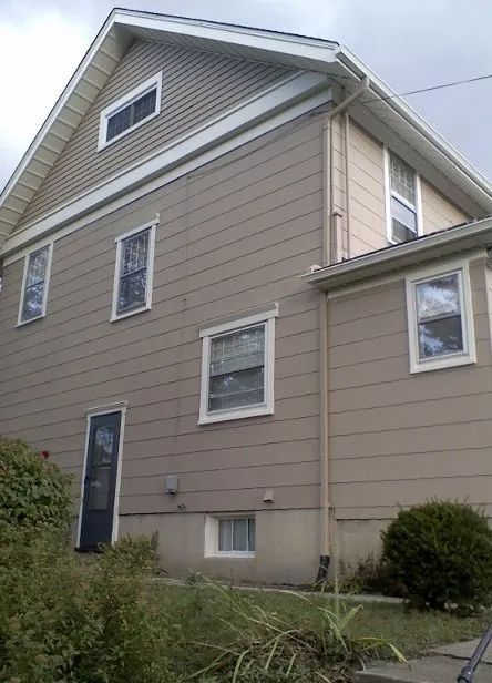 A large house with a lot of windows and a blue door