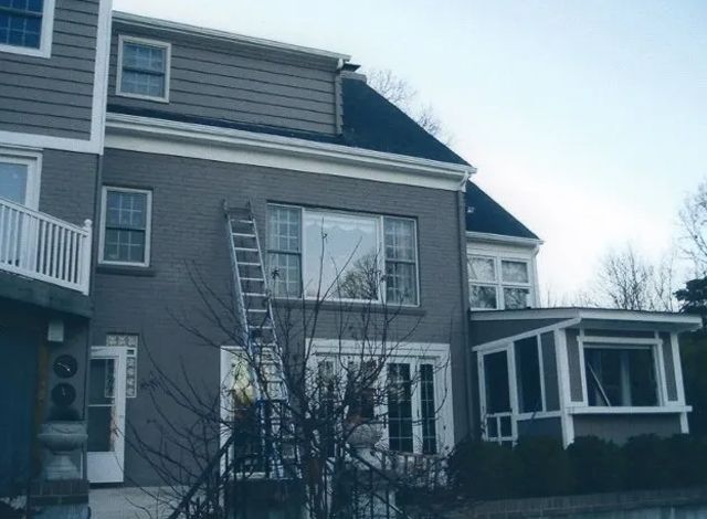 A house with a ladder on the side of it