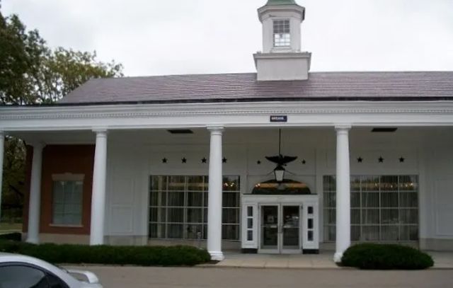 A white building with a clock tower on top of it