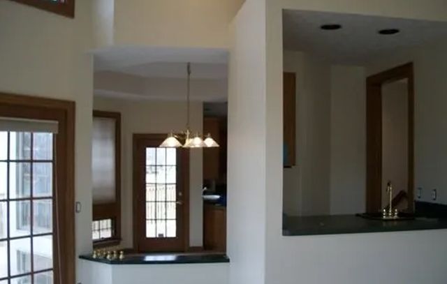 A kitchen with a sliding glass door and a sink