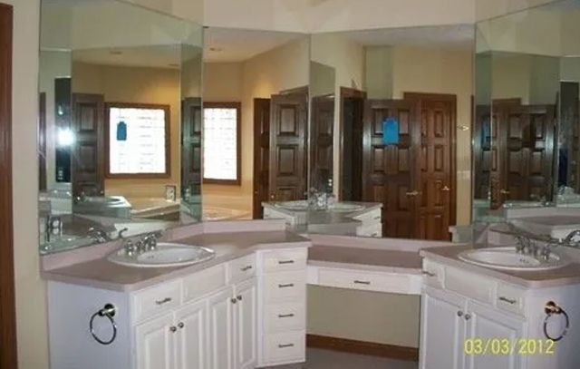 A bathroom with two sinks and a large mirror