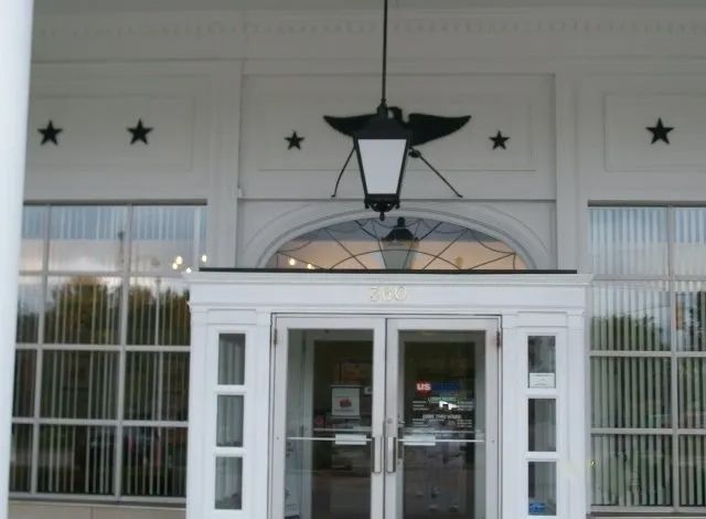A white building with a lantern hanging from the ceiling