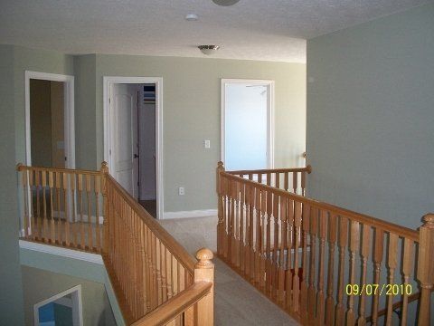 A staircase with a wooden railing in a house