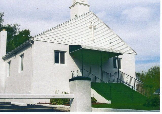 A white church with a cross on the roof