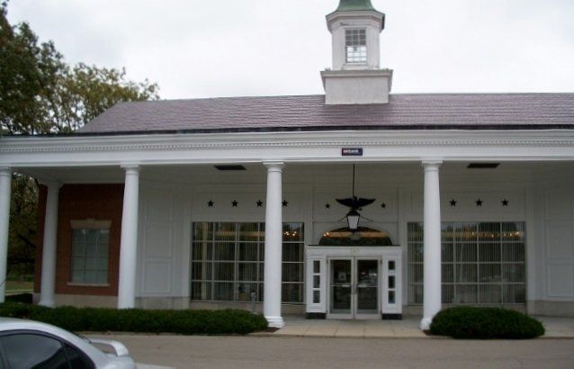 A white building with a clock tower on top of it