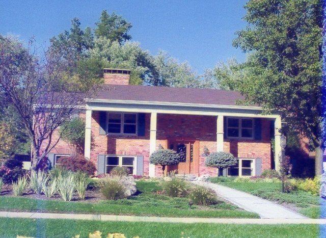 A large brick house with a large porch