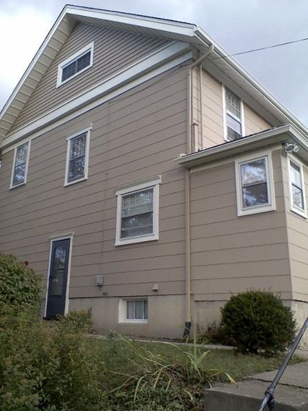 A house with a lot of windows and a black door