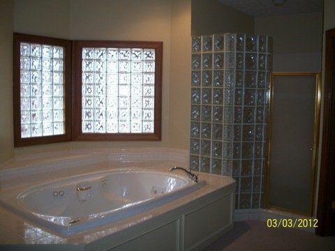 A bathroom with a jacuzzi tub and a shower.
