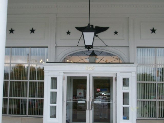 A white building with a lantern hanging from the ceiling