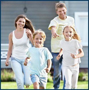 Happy family running on lawn