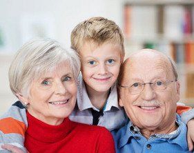 Old couple and small kid smile