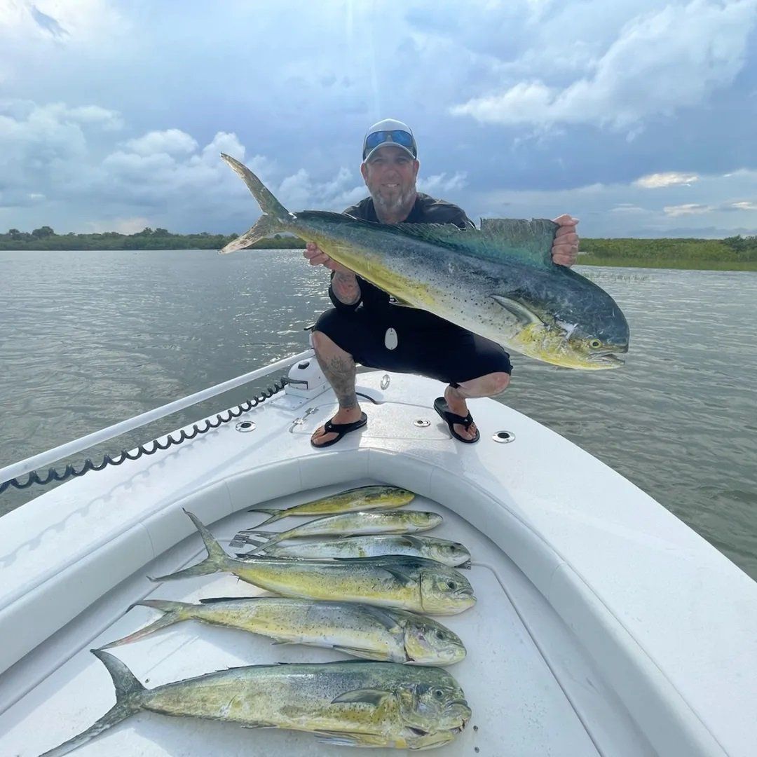 man with cap holding angler catch