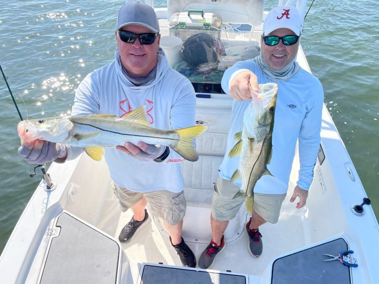 men standing with angler their angler catch